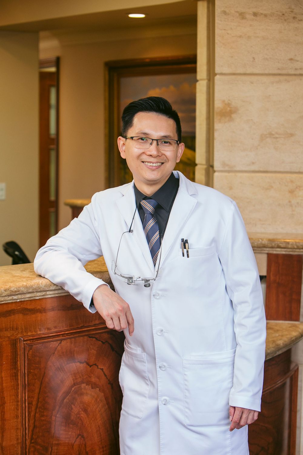 Two dentists smiling in a consultation room.